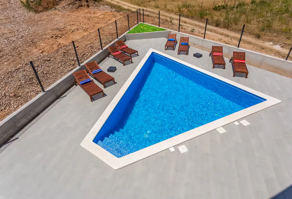 Triangular pool with olive trees