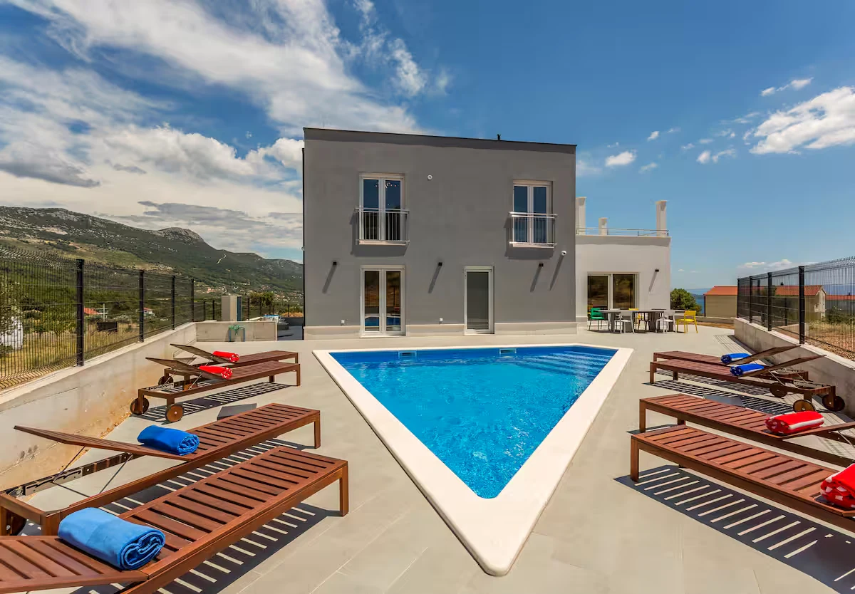 Villa Mila pool at golden hour with mountain backdrop